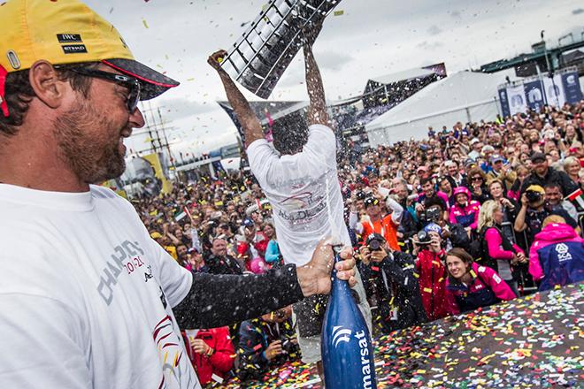 Azzam's Boat Captain Daryl Wislang sprays sparkling date juice as Adil Khalid holds aloft the Volvo Ocean Race trophy in Gothenburg © Ian Roman / Volvo Ocean Race